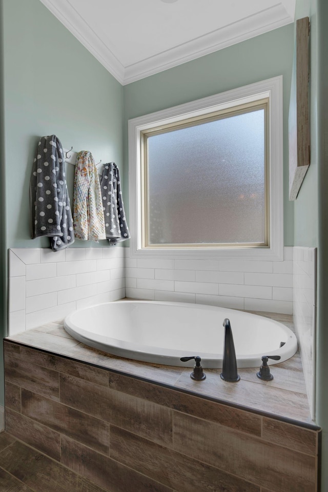 bathroom featuring a bath and ornamental molding