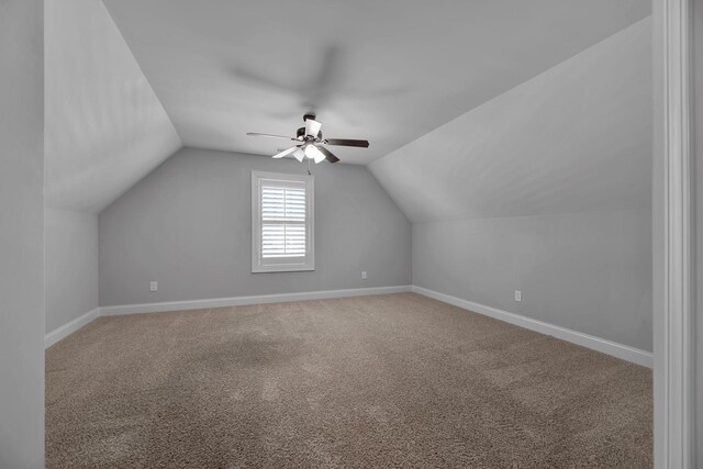 additional living space featuring carpet flooring, vaulted ceiling, and ceiling fan