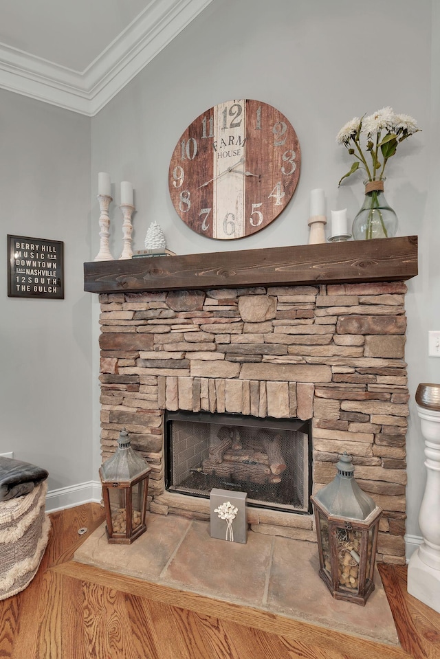 details featuring a stone fireplace and ornamental molding