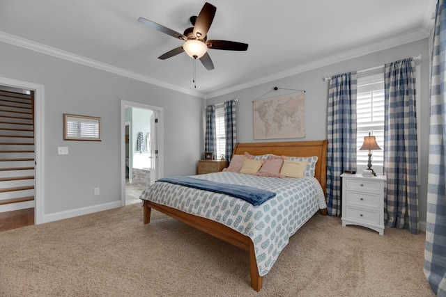 bedroom featuring ceiling fan, light colored carpet, ornamental molding, and ensuite bath