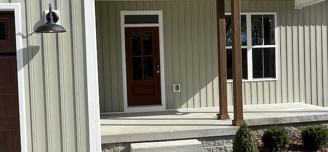 view of exterior entry with a porch