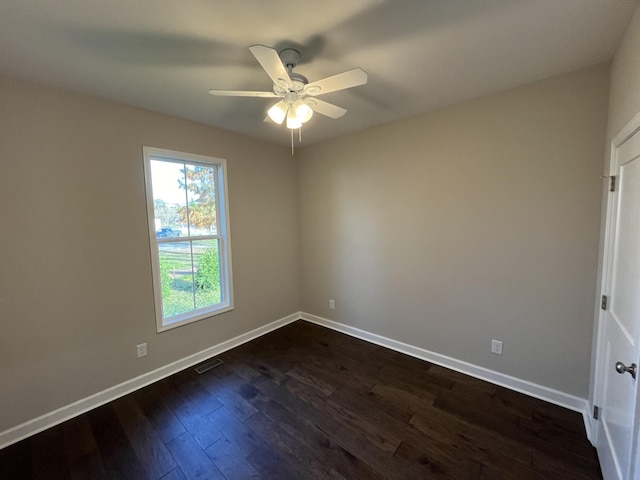 unfurnished room with ceiling fan and dark hardwood / wood-style flooring