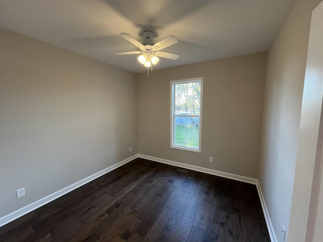 empty room featuring dark hardwood / wood-style floors and ceiling fan