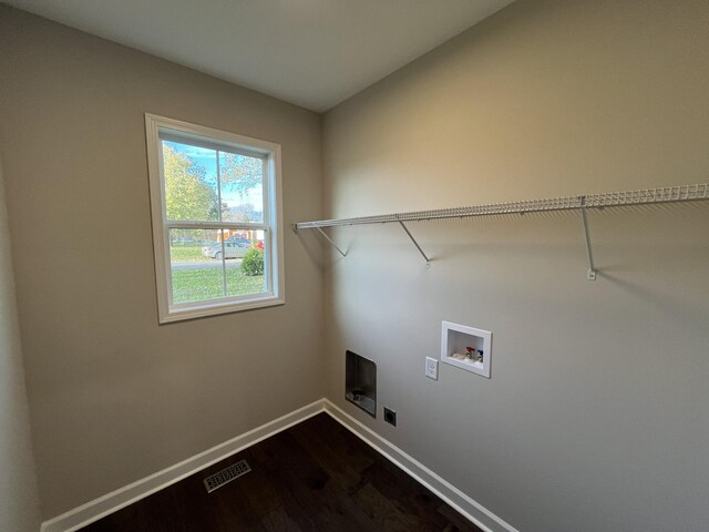 washroom featuring electric dryer hookup, dark hardwood / wood-style flooring, and washer hookup