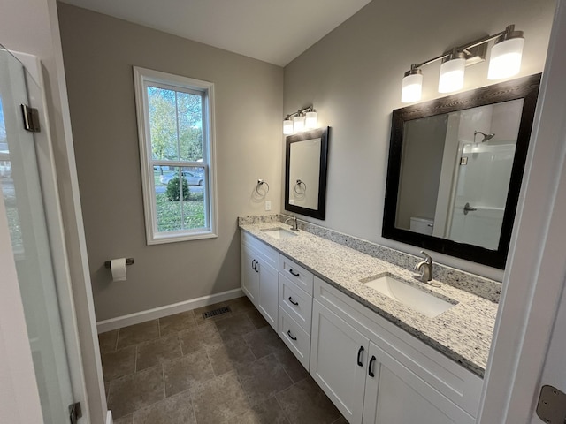 bathroom featuring toilet, vanity, and walk in shower