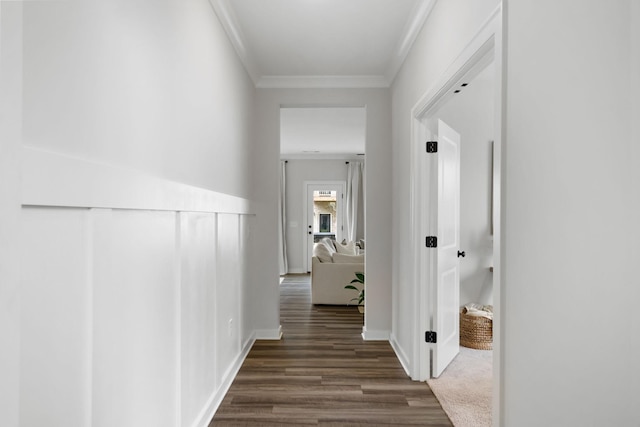 hall with dark hardwood / wood-style floors and ornamental molding