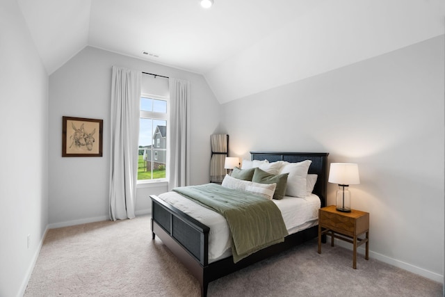 carpeted bedroom featuring vaulted ceiling