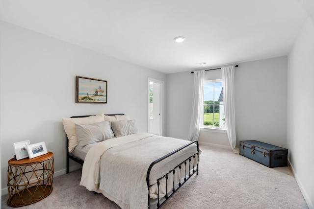 bedroom featuring light carpet