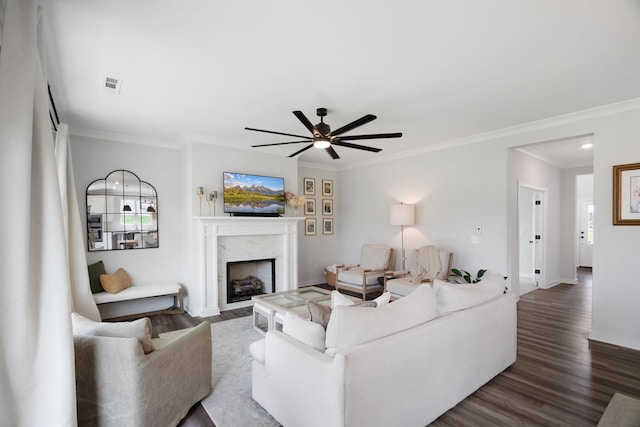 living room featuring hardwood / wood-style flooring, crown molding, and a fireplace