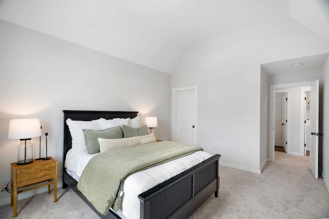 bedroom featuring light carpet and lofted ceiling