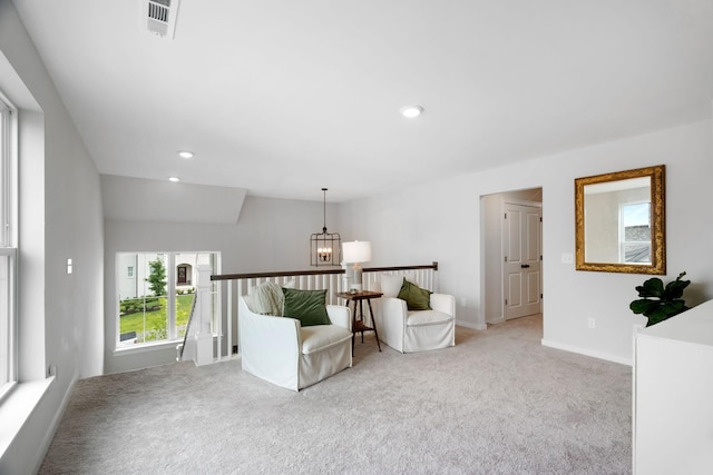 unfurnished room with light colored carpet, lofted ceiling, and a chandelier