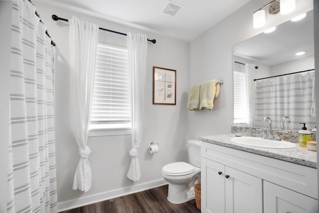 bathroom featuring hardwood / wood-style floors, vanity, and toilet