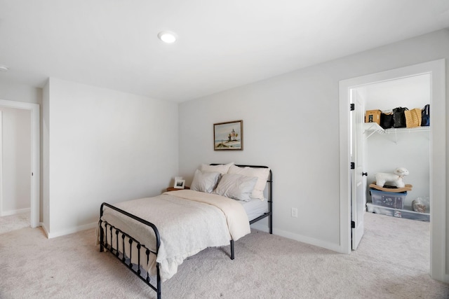 bedroom with light colored carpet and a closet