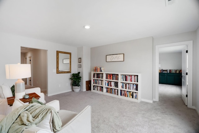 sitting room featuring light colored carpet