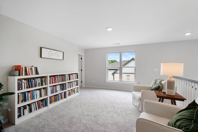 living area featuring carpet flooring