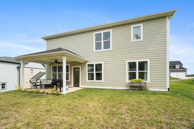 rear view of house with a lawn, ceiling fan, and a patio