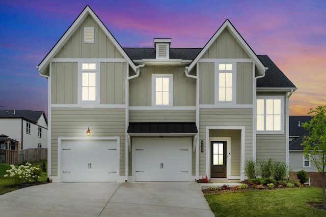 view of front facade with a garage and a lawn