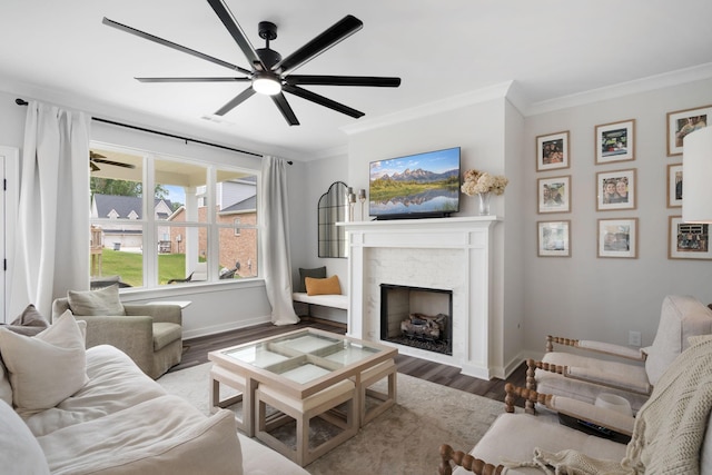 living room featuring ceiling fan, hardwood / wood-style floors, and crown molding