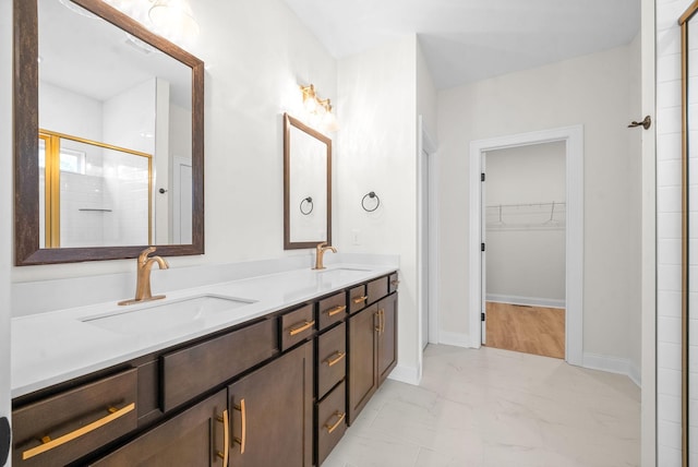 bathroom with vanity and a shower with shower door