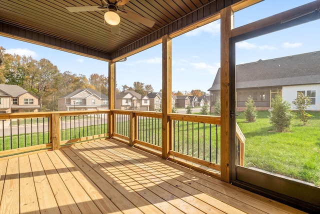 unfurnished sunroom with ceiling fan