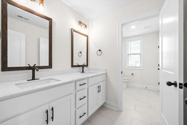 bathroom featuring vanity and toilet