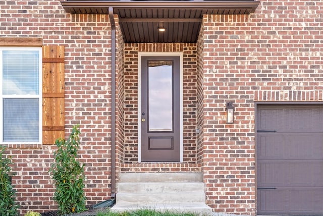 view of exterior entry featuring a garage