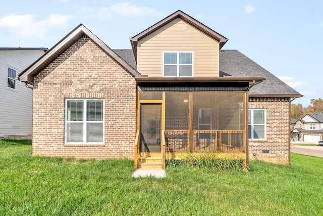 rear view of property with a sunroom and a yard