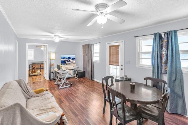 dining area with a textured ceiling, dark hardwood / wood-style floors, and ornamental molding