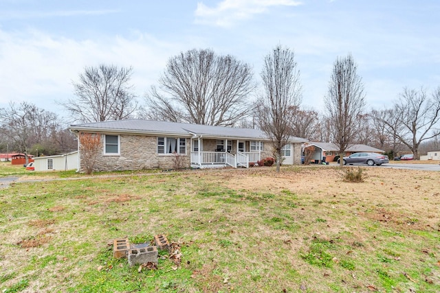 ranch-style home with covered porch and a front lawn