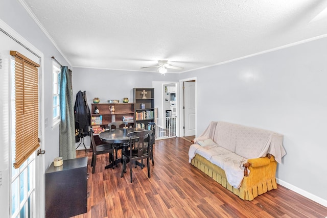 dining space with a textured ceiling, dark hardwood / wood-style floors, and crown molding