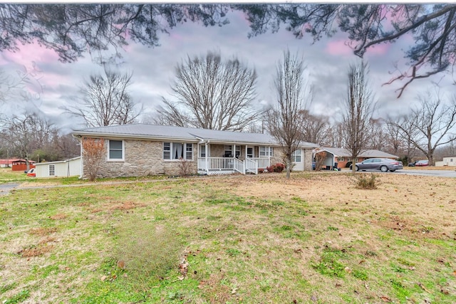 single story home with a porch and a front yard