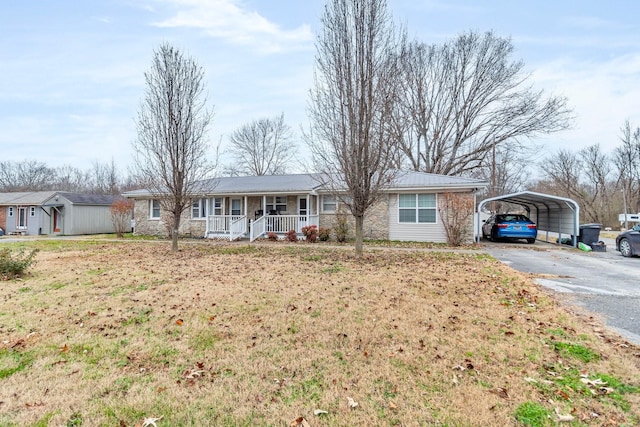 ranch-style home featuring a porch and a carport