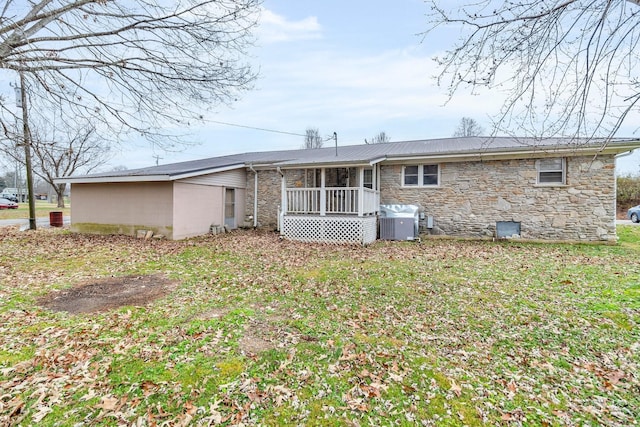 rear view of property with a yard