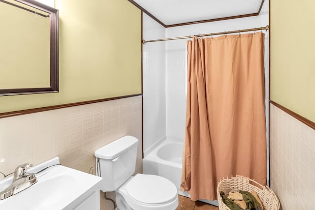 full bathroom with toilet, sink, shower / bathtub combination with curtain, and tile walls