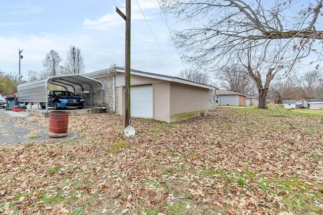 view of side of home with a carport and a garage