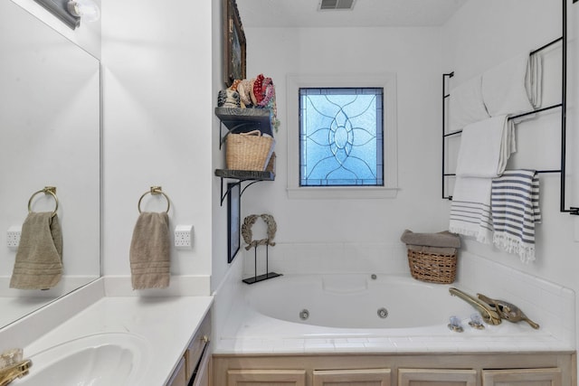 bathroom with vanity and a washtub