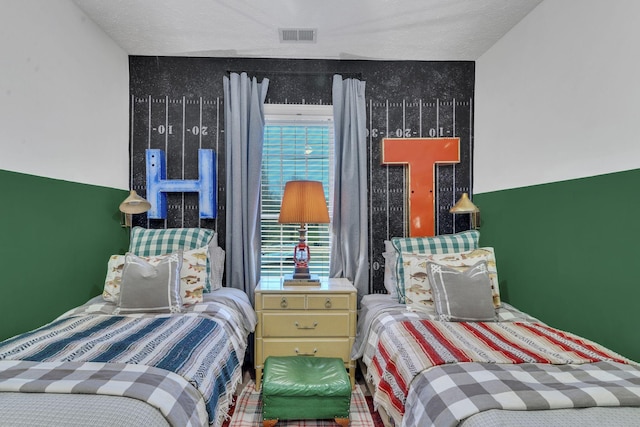 bedroom featuring multiple windows and a textured ceiling