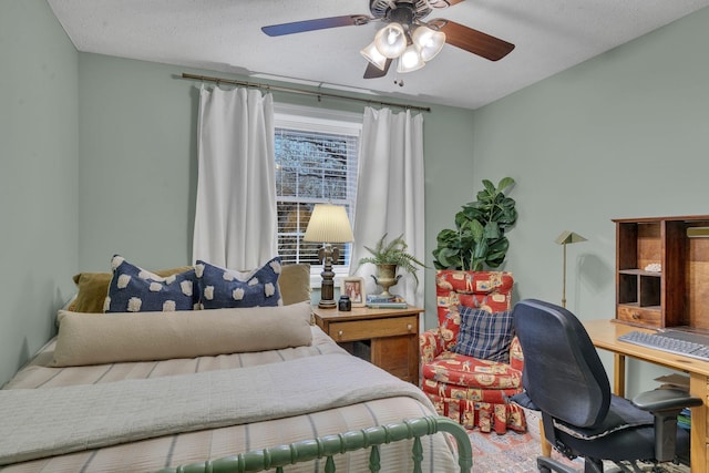 bedroom featuring ceiling fan and a textured ceiling