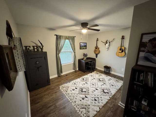 sitting room with dark hardwood / wood-style floors and ceiling fan