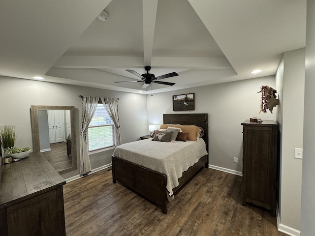 bedroom featuring beamed ceiling, dark hardwood / wood-style floors, and ceiling fan