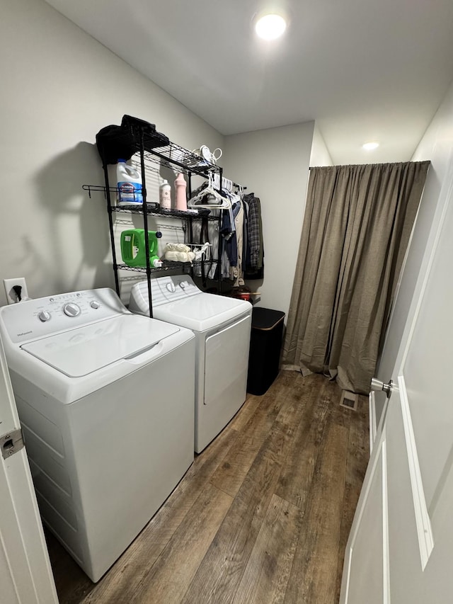 washroom featuring hardwood / wood-style floors and washer and dryer