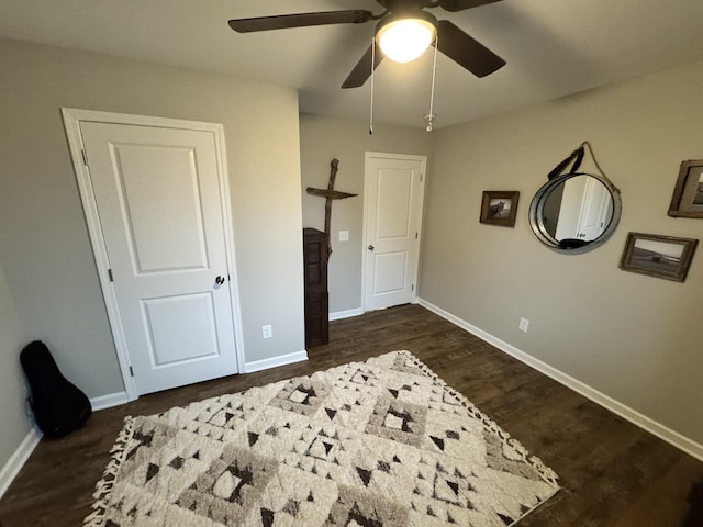 bedroom featuring ceiling fan and dark wood-type flooring