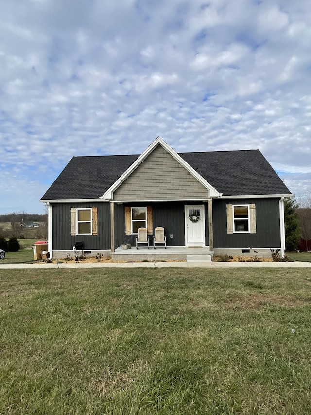 ranch-style home featuring a porch and a front lawn