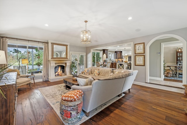 living room with a chandelier and dark hardwood / wood-style flooring