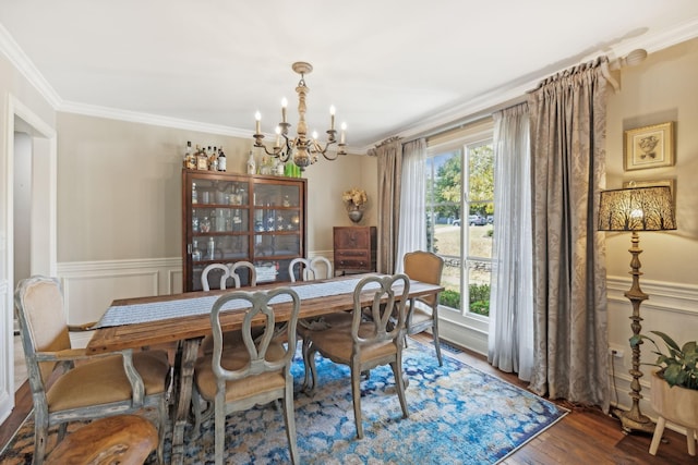 dining room with wood-type flooring, ornamental molding, a wealth of natural light, and a notable chandelier