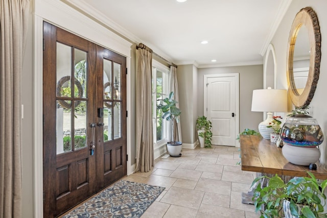 tiled foyer featuring crown molding and french doors