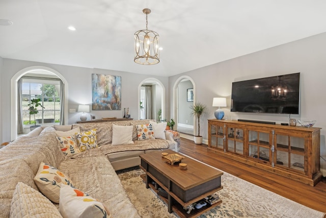 living room featuring wood-type flooring and a notable chandelier