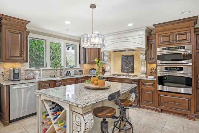 kitchen with a center island, light stone counters, pendant lighting, decorative backsplash, and appliances with stainless steel finishes