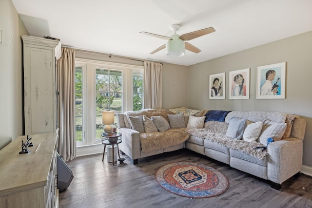 living room featuring dark hardwood / wood-style flooring and ceiling fan