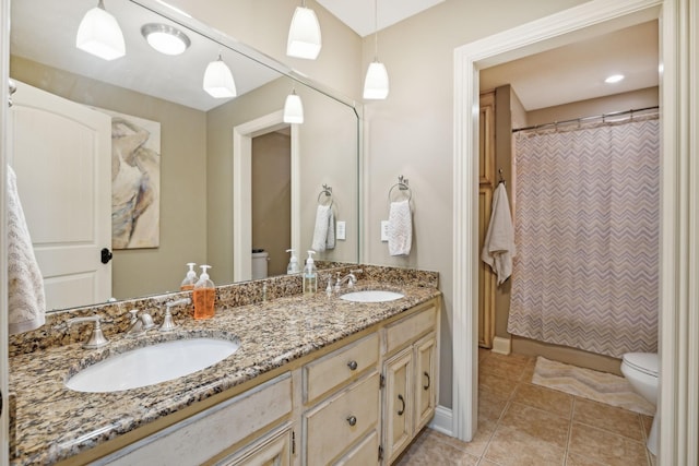 bathroom with tile patterned flooring, a shower with curtain, vanity, and toilet